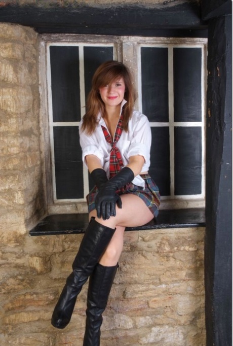Redheaded girl exposes her breasts in leather gloves and boots 17438900