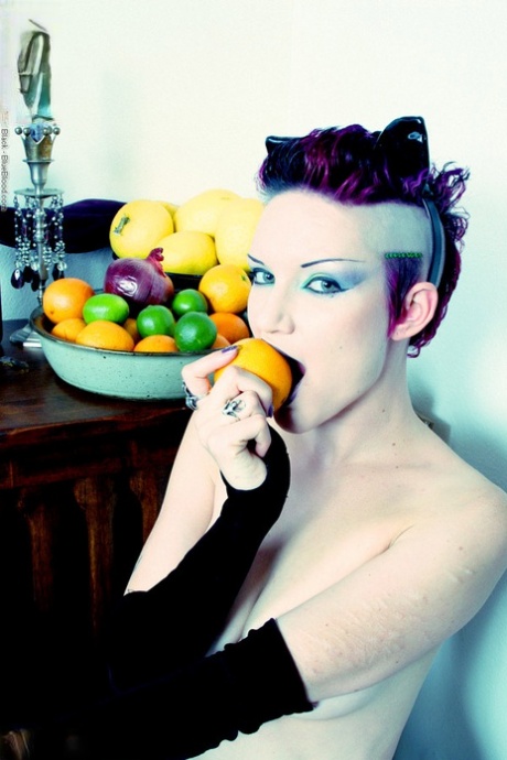 Alt girl Scar 13 bites into an in orange and a lemon while totally naked 44903039