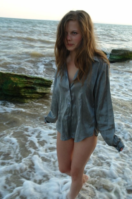 Nice teen girl Petra E removes her shirt after wading out into the ocean 24735976