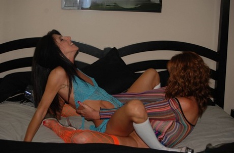 Mature redhead Dee Delmar has lesbian sex with a younger girl on a bed 72321593