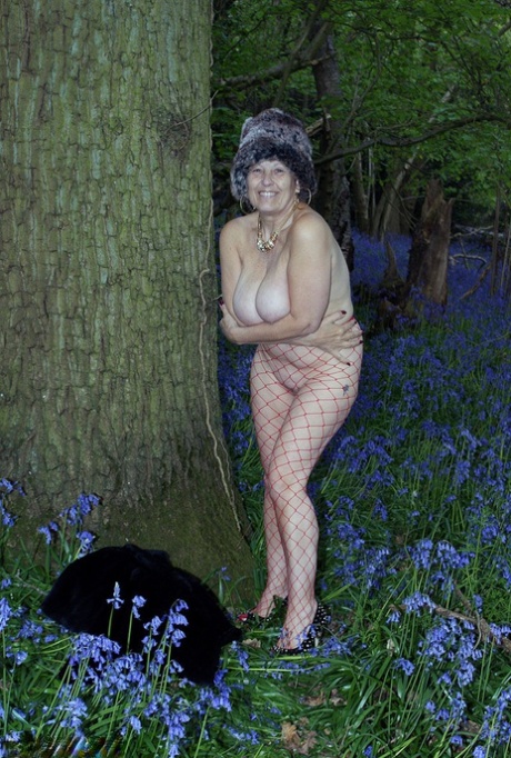Mature lady removes her winter coat to show her big naturals in mesh pantyhose 18728979