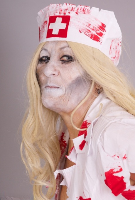 Old blonde amateur Savana removes a nurse uniform during a cosplay scene 80549029