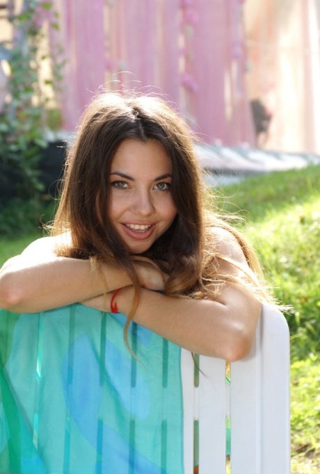 Young brunette Naomi G shows off her naked body in a lawn chair 37270683