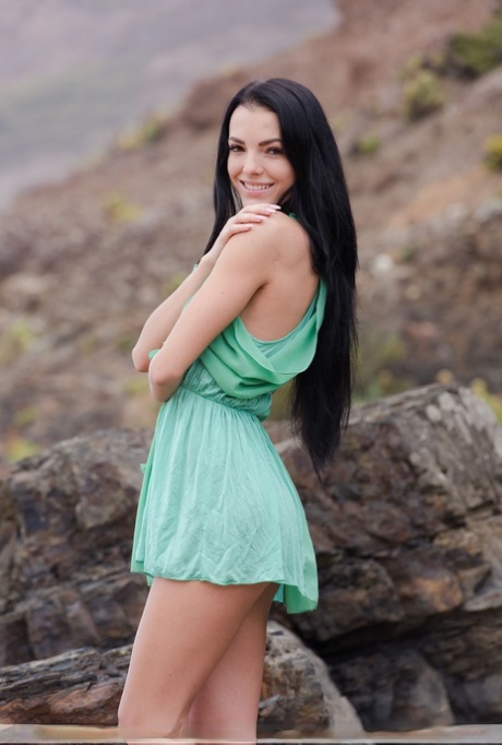Brunette teen Sapphira gets butt naked on exposed rock at the beach 97109858