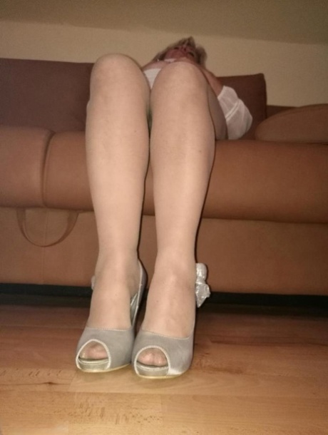 Mature lady exposes her large tits while having a smoke in pantyhose 71963215