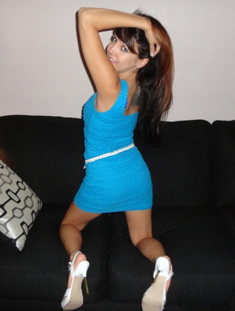 Teen solo girl Andi Land strips down to her heels on a sofa by candlelight 96489314