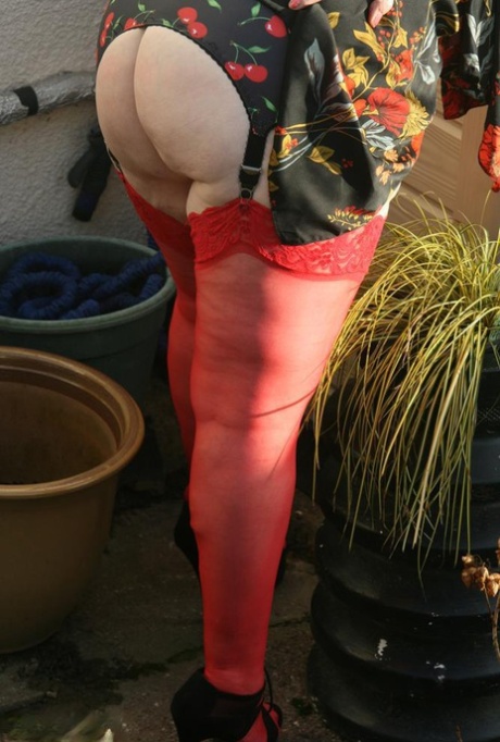 Naughty granny shows her tits and twat in backyard wearing red stockings 98117541
