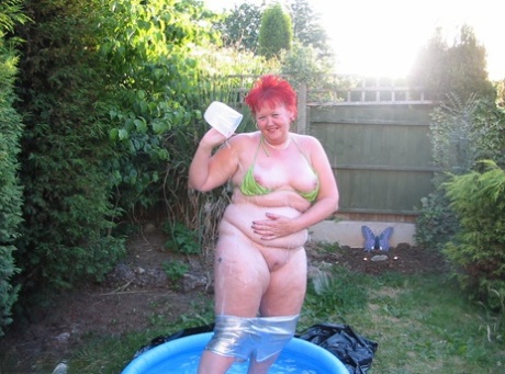 Older redheaded BBW Valgasmic Exposed plays with a dildo in a wading pool 35513020