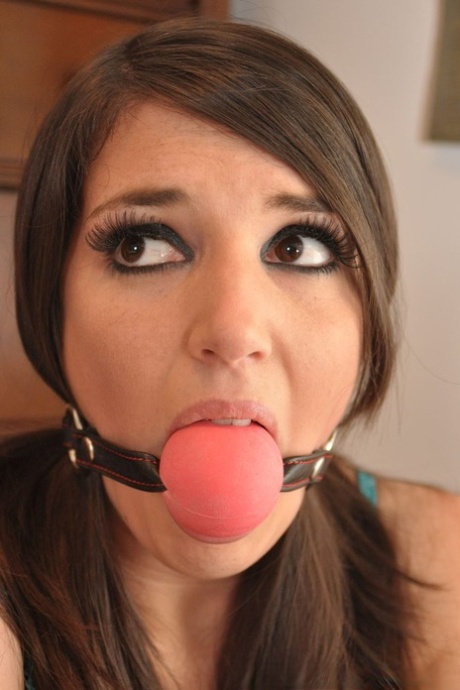 Beautiful girl is attached to a spreader bar while handcuffed and ball gagged 18374149