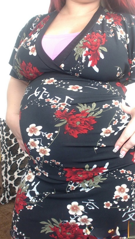 Pregnant redhead Georgia Peach takes her dress off and poses naked on the sofa 50487037