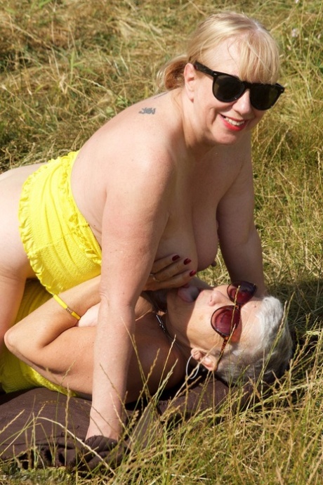 Silver haired granny Savana engages in lesbian play while in a field 44882787
