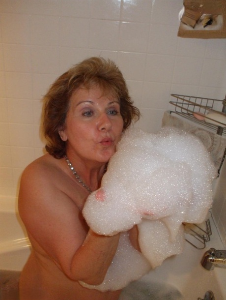 Older amateur Busty Bliss licks her lips during a playful bubble bath 83007363