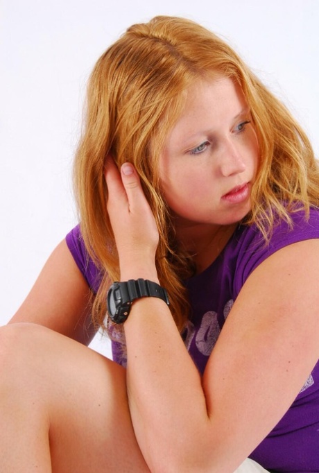 Natural redhead Judy models a black G-Shock watch while fully clothed 70357395