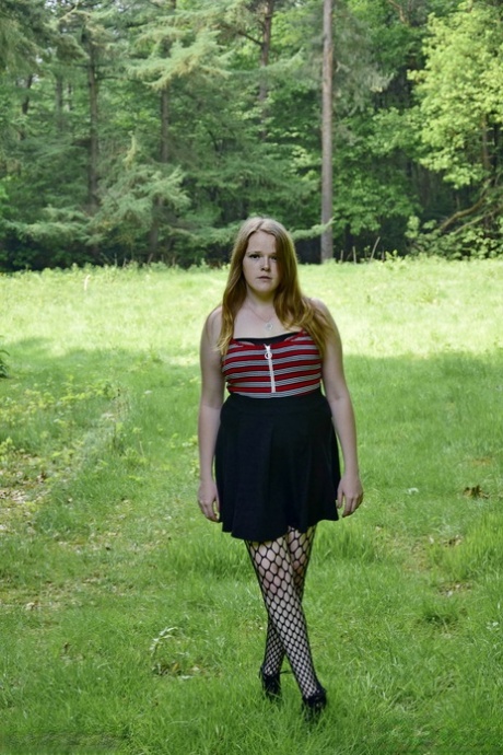 Redheaded amateur exposes her tits during upskirt action in a field 89977450
