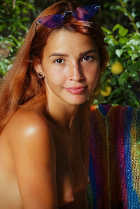 Redheaded Latina teen Agatha Vega poses naked in a patio garden 96535401