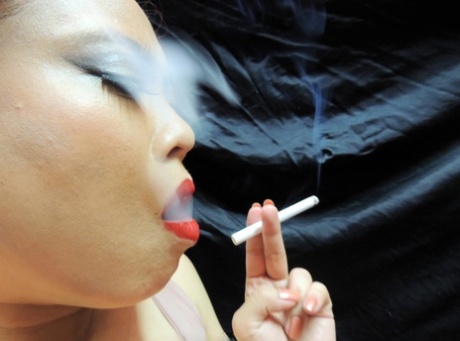 Asian MILF Jasmine Jade wears her hair pulled back while smoking 58795607