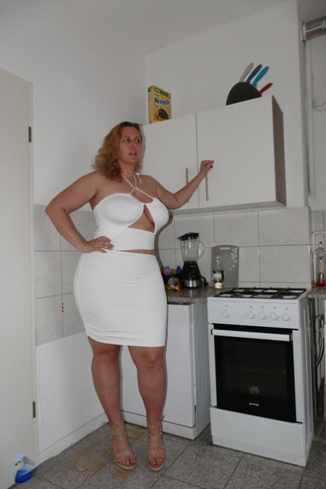 Mature woman Kathy D plays with her big tits before sex in a kitchen 58713400