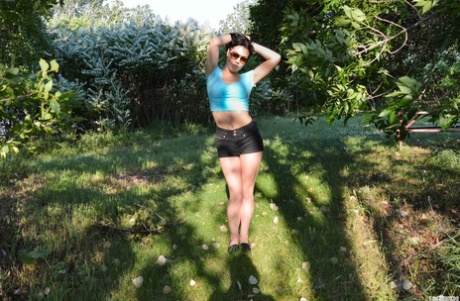 Brunette teen Shana Lane works her tits loose outdoors on a picnic table 22381397