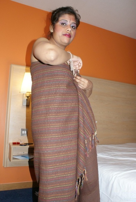 Cute Indian woman Rupali puts her plump body on display atop a hotel room bed 86566207