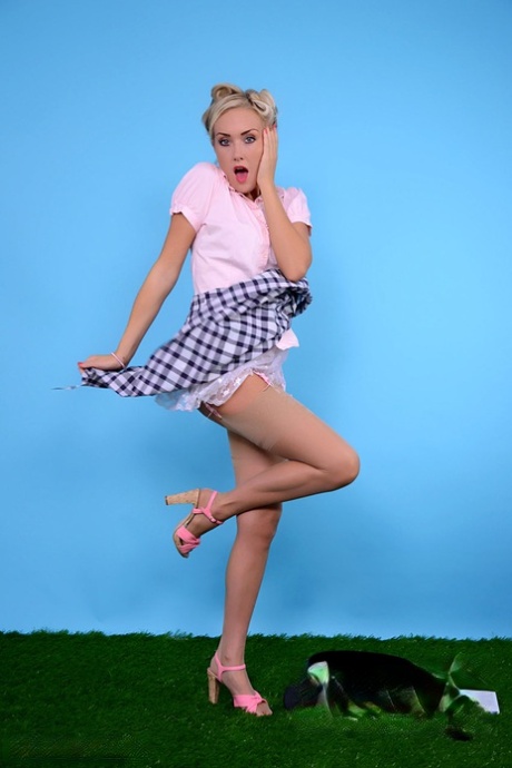 Blonde pinup model lets her hair down while going topless in a casual manner 24304997