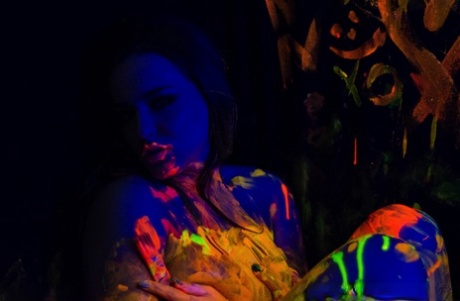 Solo girl Natasha Nice plays with her big tits underneath black lights 12786462