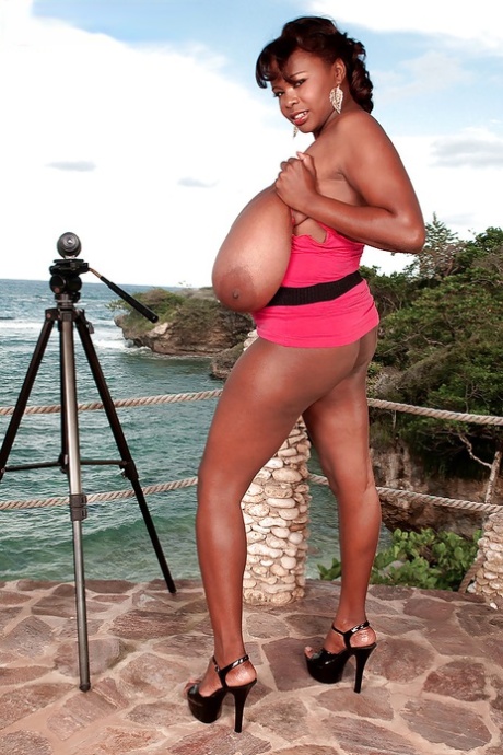 Sexy ebony girl exposing her extremely big black tits on the balcony 97390949