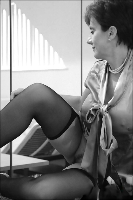 Mature lady stripping in front of the mirror and picturing herself 14876249